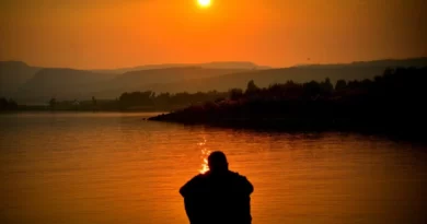 Solo traveller sitting near sun set